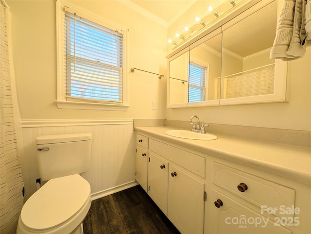 bathroom featuring vanity, hardwood / wood-style flooring, toilet, and ornamental molding