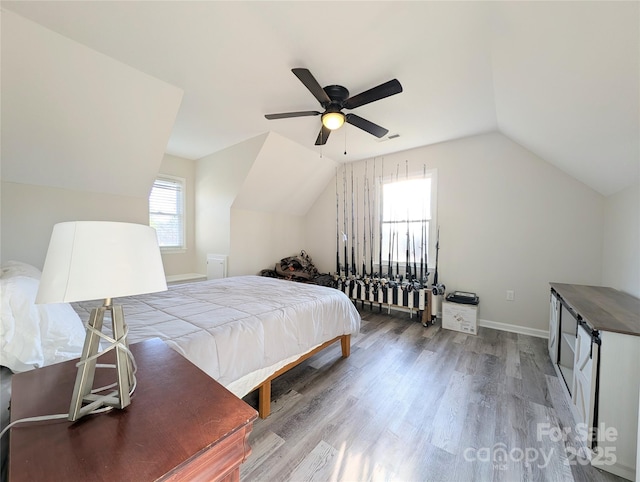 bedroom with hardwood / wood-style flooring, ceiling fan, and lofted ceiling