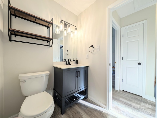 bathroom with hardwood / wood-style floors, vanity, and toilet