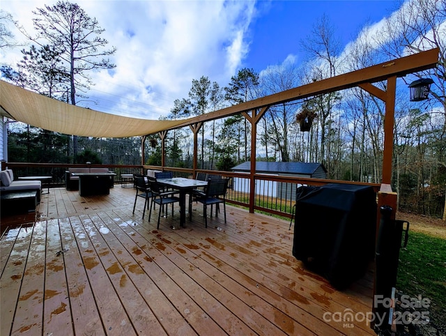 wooden deck featuring an outdoor fire pit