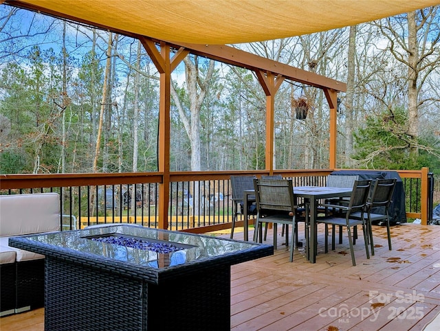 wooden terrace featuring a fire pit