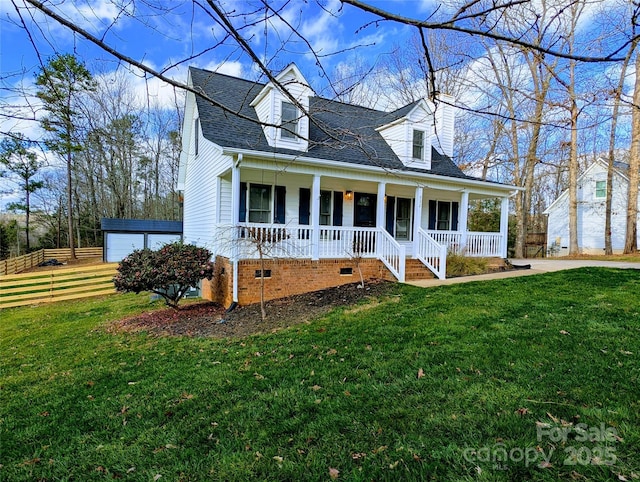 cape cod house featuring a garage, covered porch, an outdoor structure, and a front yard