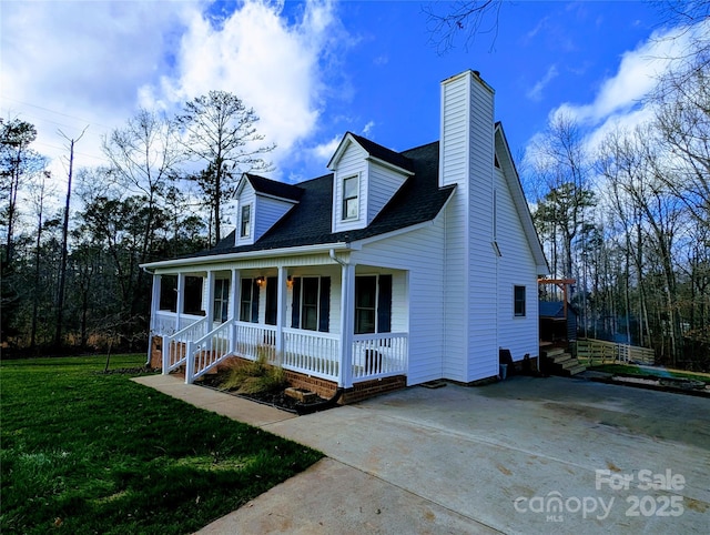 cape cod-style house with covered porch and a front yard