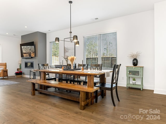 dining space featuring a notable chandelier and dark wood-type flooring