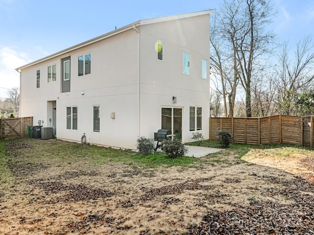 rear view of house featuring central air condition unit and a patio