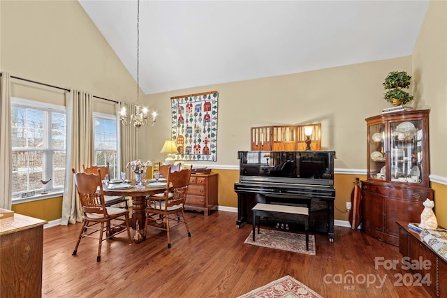 dining space featuring hardwood / wood-style floors, vaulted ceiling, and a chandelier