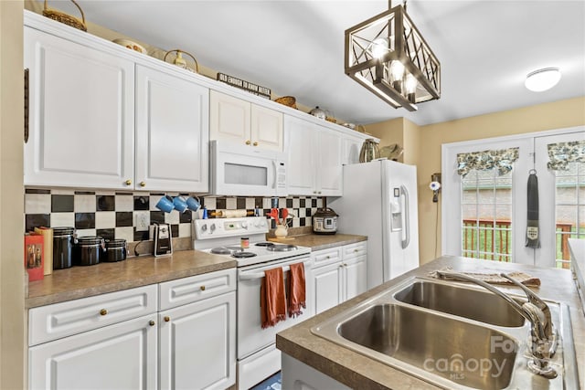 kitchen featuring backsplash, white cabinets, hanging light fixtures, and white appliances