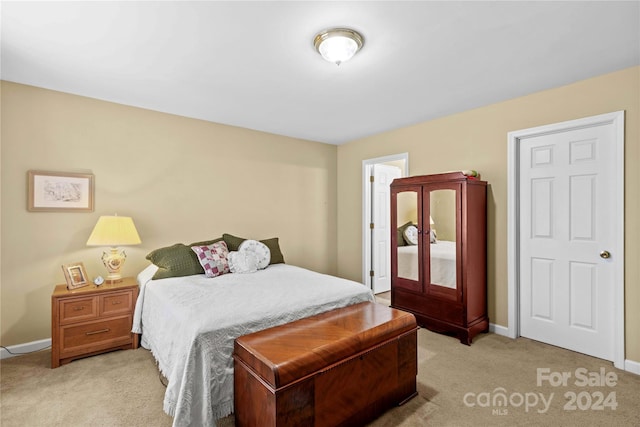 bedroom featuring light carpet