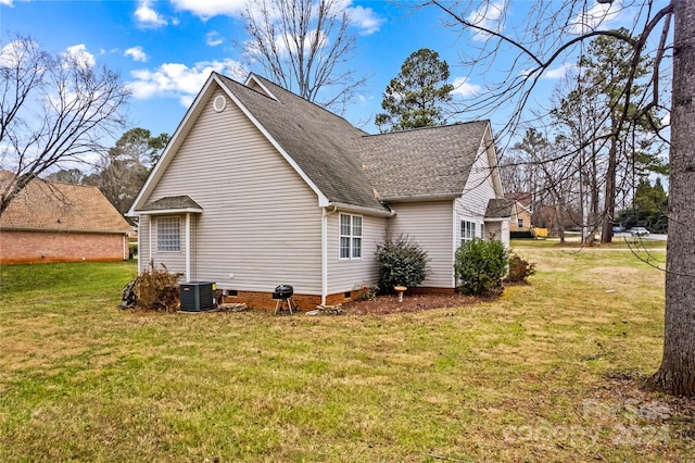 rear view of property with a lawn and central AC unit