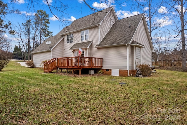 back of property with a yard and a deck