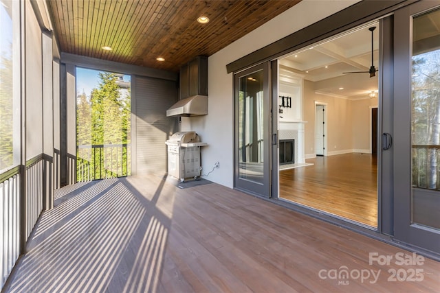 unfurnished sunroom with beamed ceiling and coffered ceiling