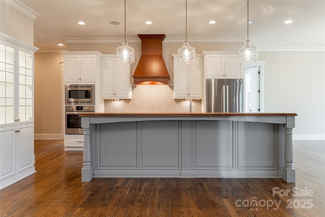 kitchen featuring recessed lighting, premium range hood, backsplash, stainless steel appliances, and white cabinets