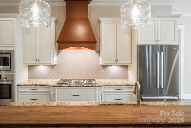 kitchen featuring white cabinetry, custom exhaust hood, appliances with stainless steel finishes, and decorative backsplash