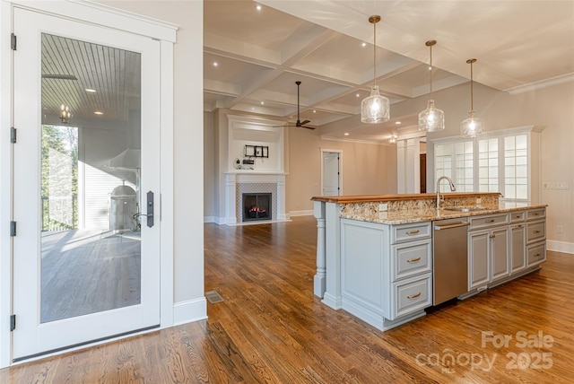 kitchen with baseboards, a sink, a ceiling fan, and stainless steel dishwasher