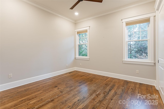 unfurnished room with a ceiling fan, baseboards, ornamental molding, visible vents, and dark wood-type flooring