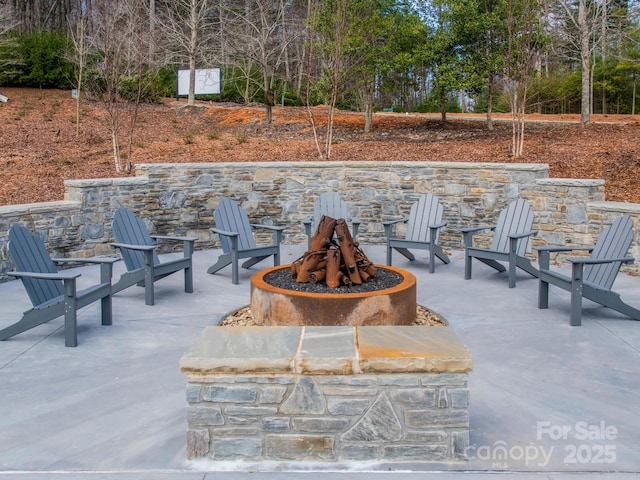 view of patio / terrace featuring an outdoor fire pit