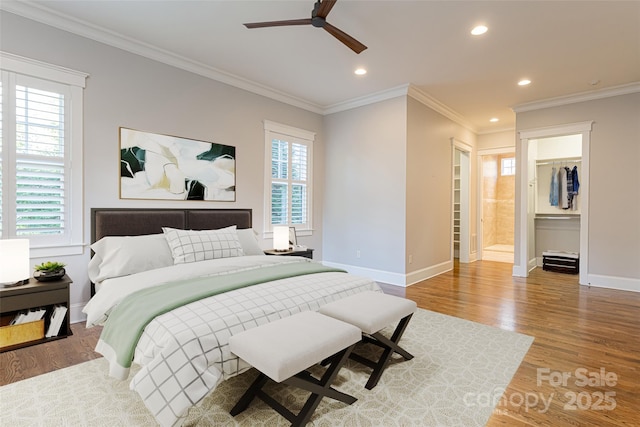 bedroom with baseboards, crown molding, recessed lighting, and wood finished floors