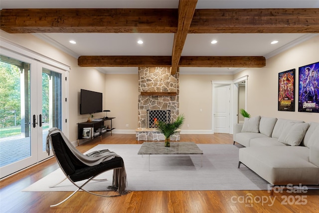 living area with recessed lighting, ornamental molding, beam ceiling, and wood finished floors