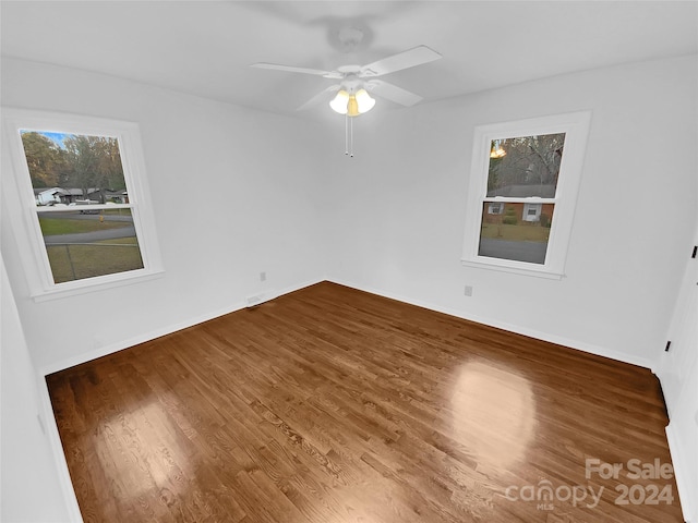 empty room with ceiling fan and hardwood / wood-style floors