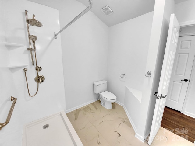 bathroom featuring toilet and a shower