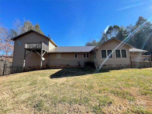 rear view of property with a lawn