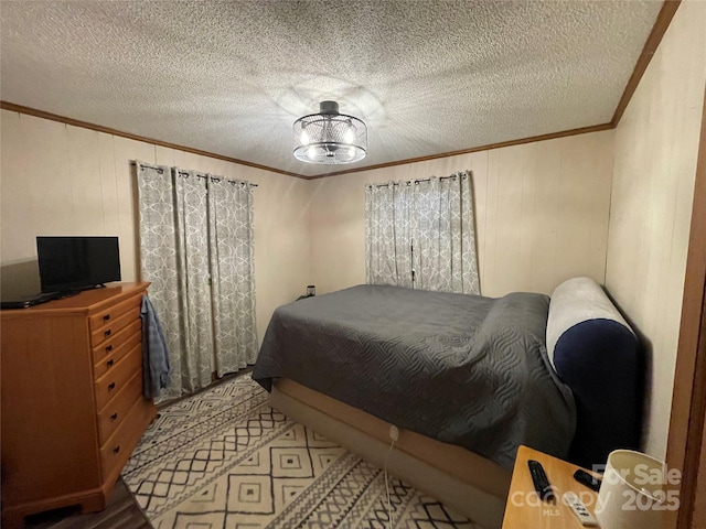 bedroom featuring ornamental molding and a textured ceiling