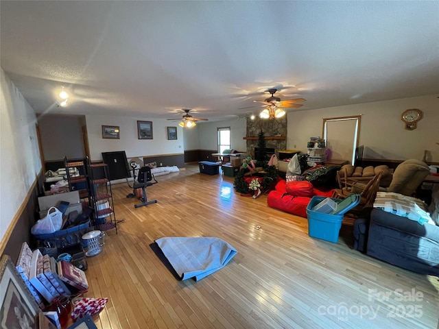 living room featuring hardwood / wood-style flooring and ceiling fan