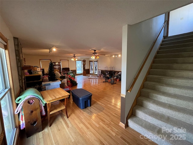 living room with hardwood / wood-style floors and a textured ceiling