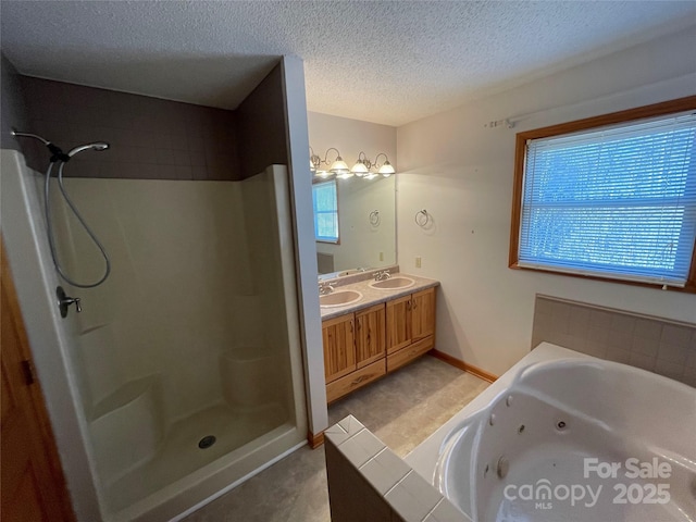 bathroom featuring vanity, separate shower and tub, and a textured ceiling