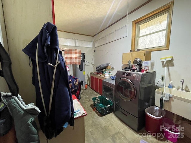 clothes washing area featuring washer / dryer, sink, cabinets, a textured ceiling, and water heater