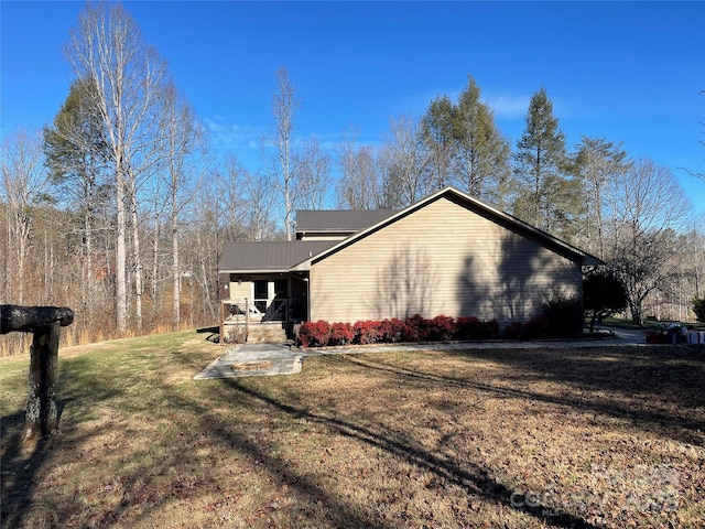 view of side of property with a lawn