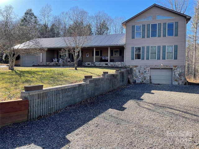 view of front of house featuring a garage and a front lawn