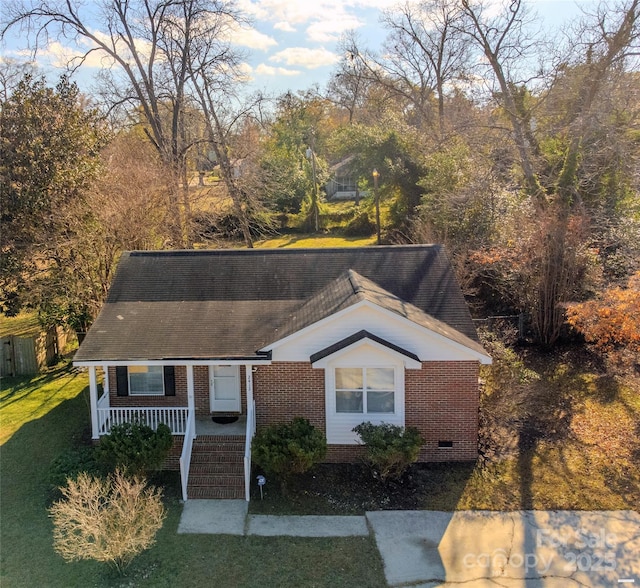 view of front of property with a porch and a front yard