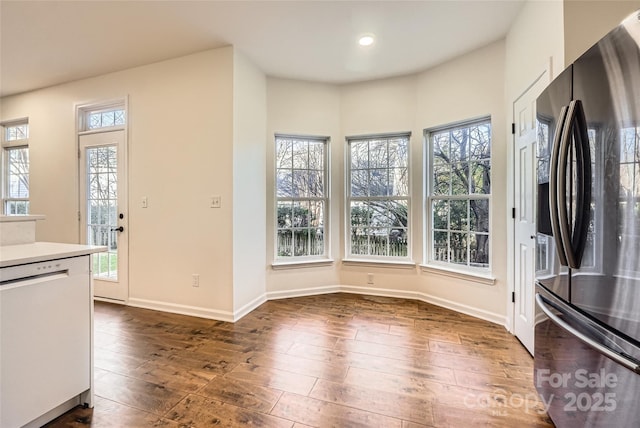 kitchen featuring white dishwasher, refrigerator, white cabinets, and dark wood-type flooring