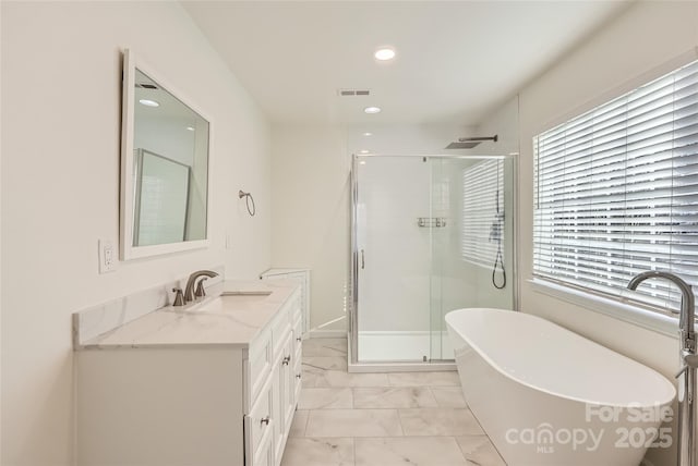 bathroom with vanity and separate shower and tub