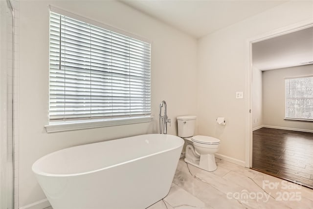 bathroom with toilet and a bathtub