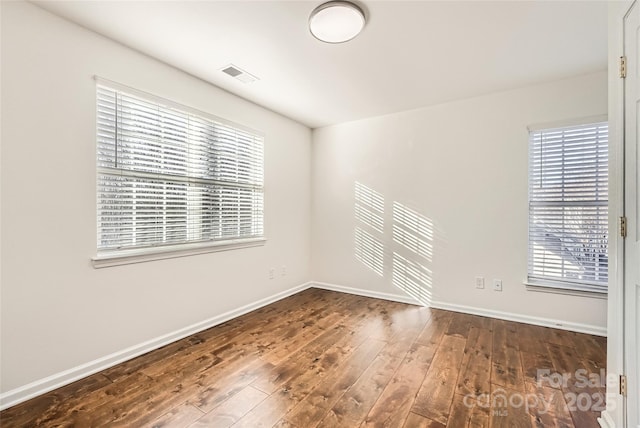 empty room with dark wood-type flooring