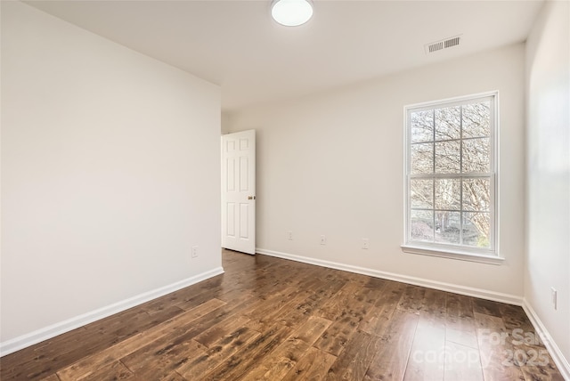 unfurnished room with dark hardwood / wood-style floors