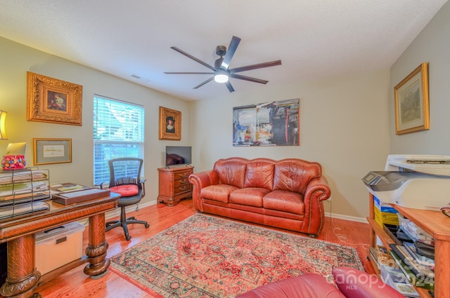 office space with ceiling fan and light hardwood / wood-style floors