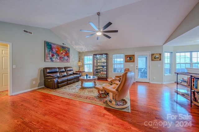 living room featuring ceiling fan, wood-type flooring, and vaulted ceiling