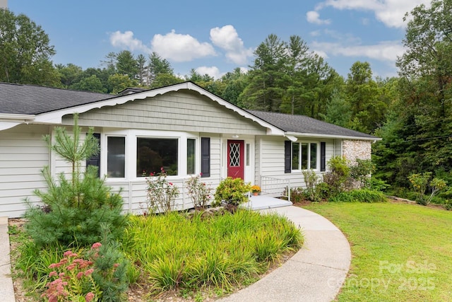 ranch-style house with a front lawn