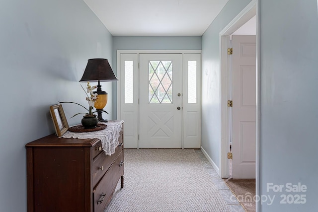 entrance foyer featuring light colored carpet