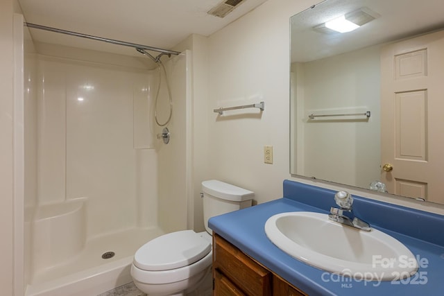 bathroom with toilet, walk in shower, and vanity