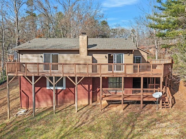 rear view of property featuring a yard and a deck