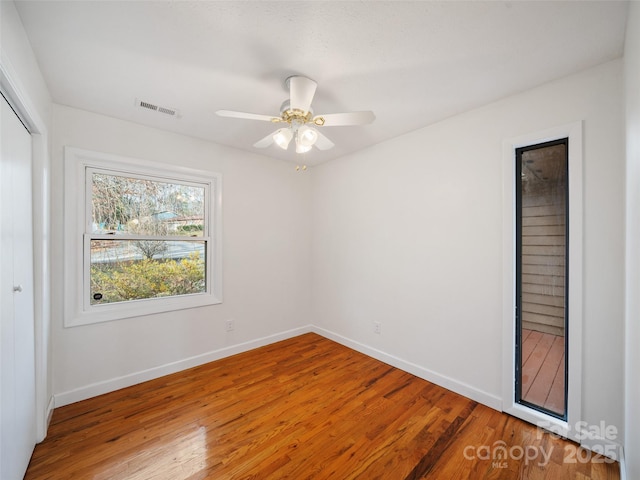 unfurnished room featuring ceiling fan and hardwood / wood-style floors