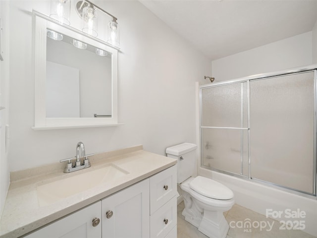 full bathroom with vanity, toilet, and shower / bath combination with glass door