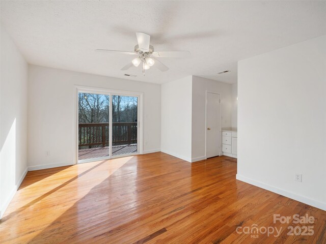 spare room featuring light hardwood / wood-style floors and ceiling fan