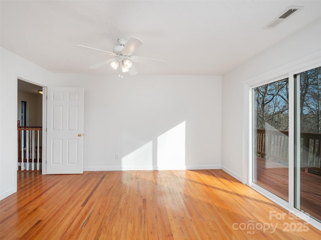 spare room featuring light hardwood / wood-style flooring and ceiling fan