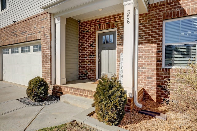 doorway to property with a porch and a garage