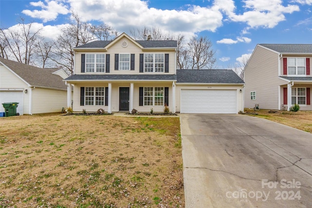 view of front property featuring a garage and a front yard